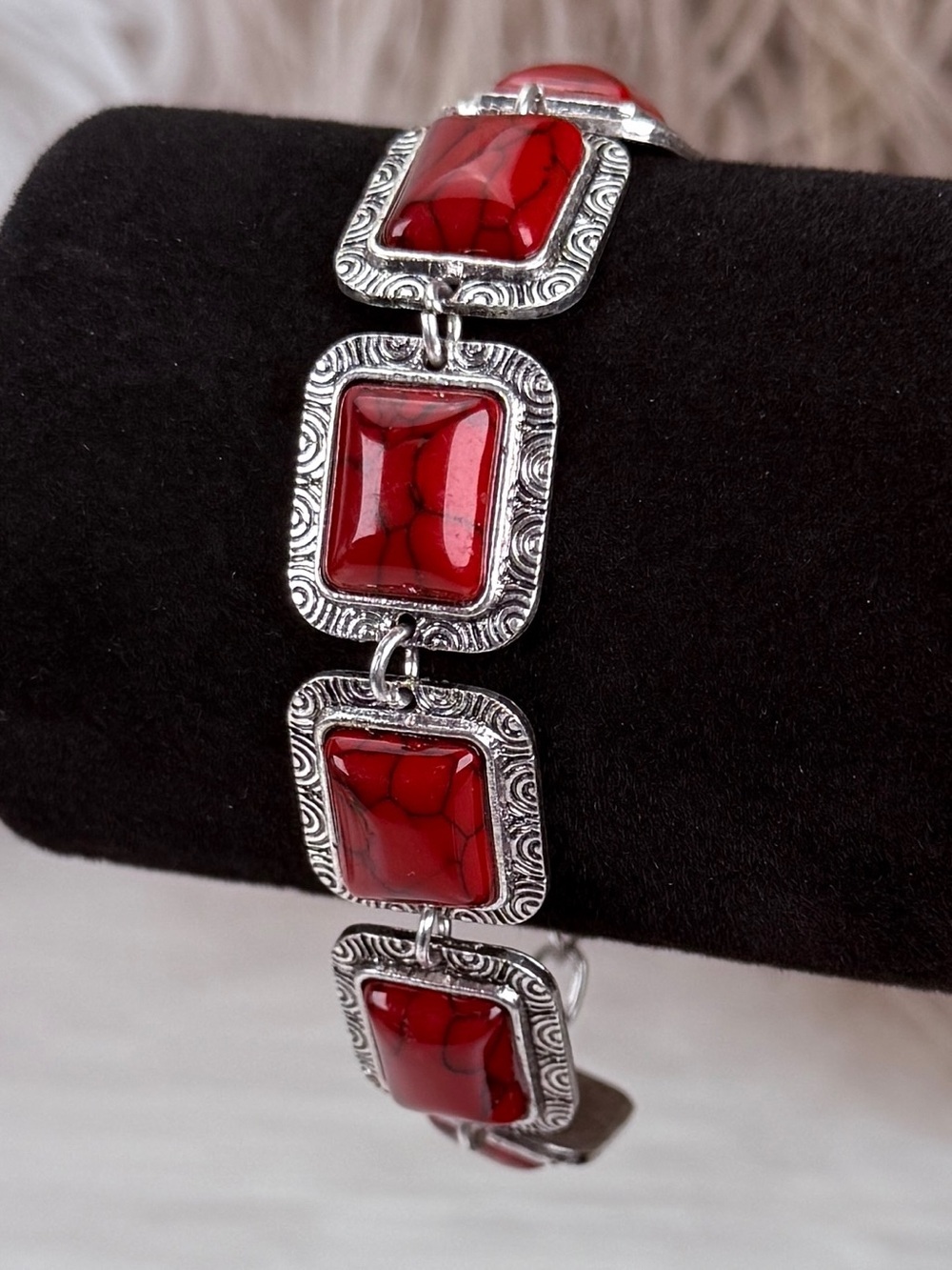 Pretty silvertone with red bracelet with toggle closure
